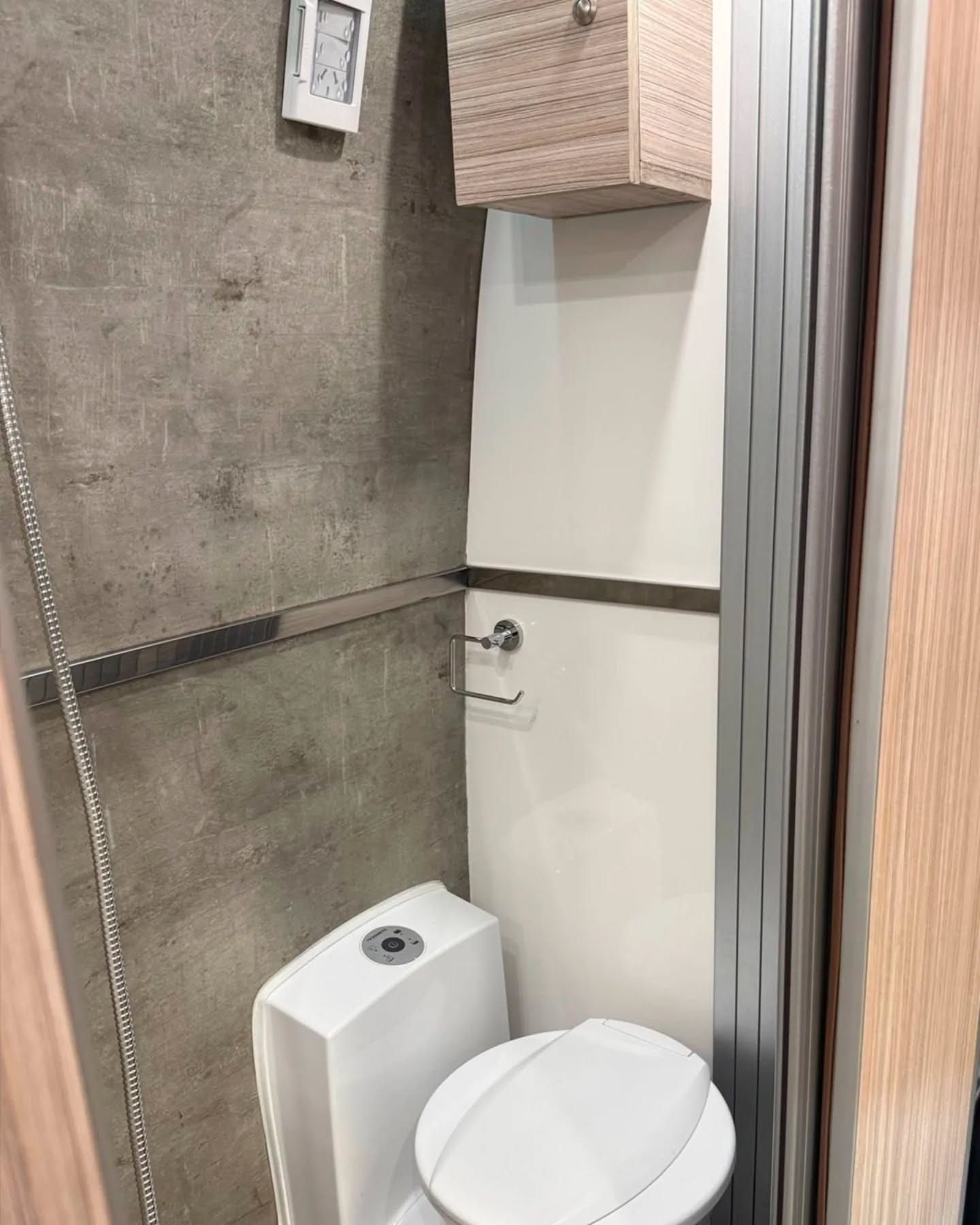 Dometic toilet with electric flush inside the washroom cubicle