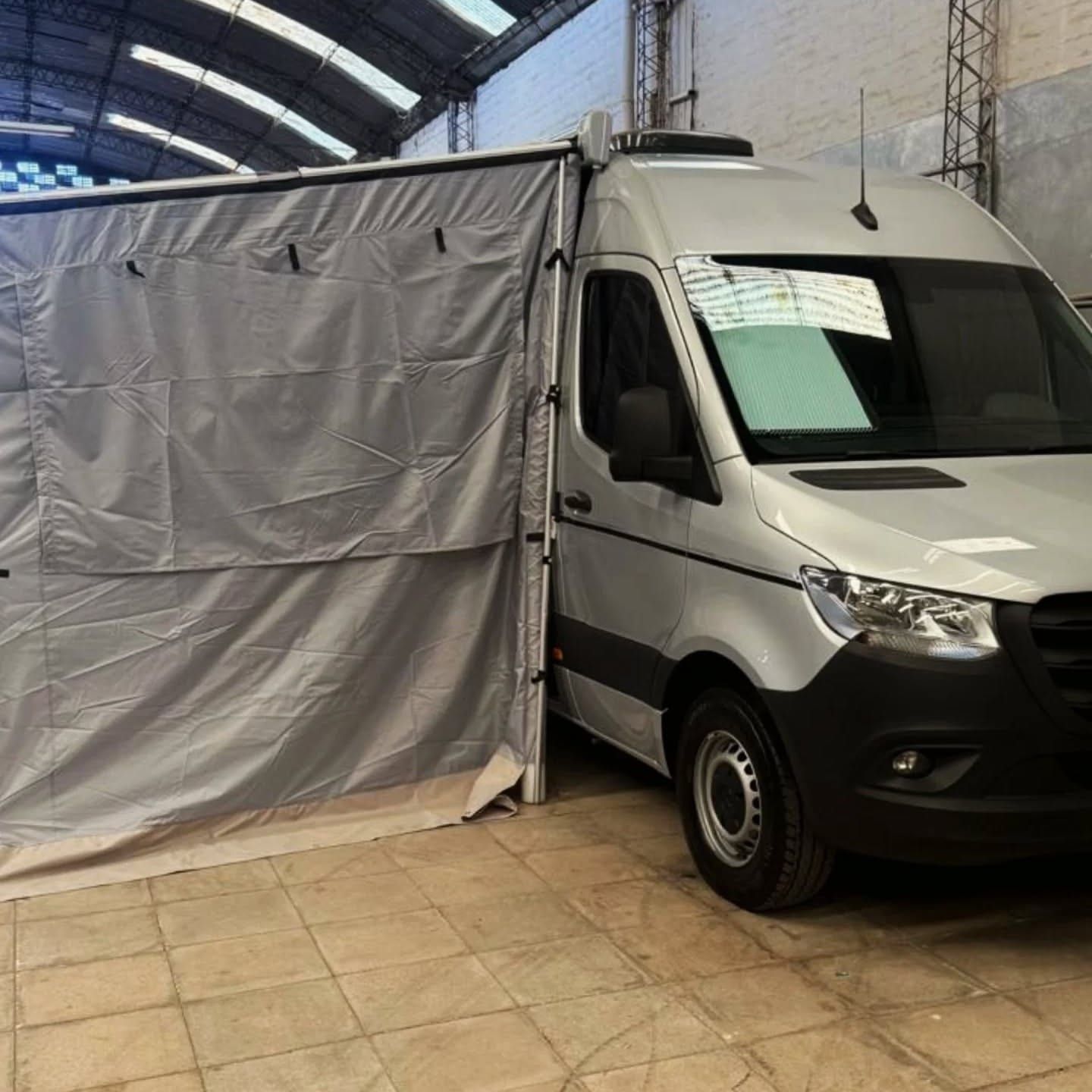 Side awning with zip-on walls set up on the Sprinter, at the workshop